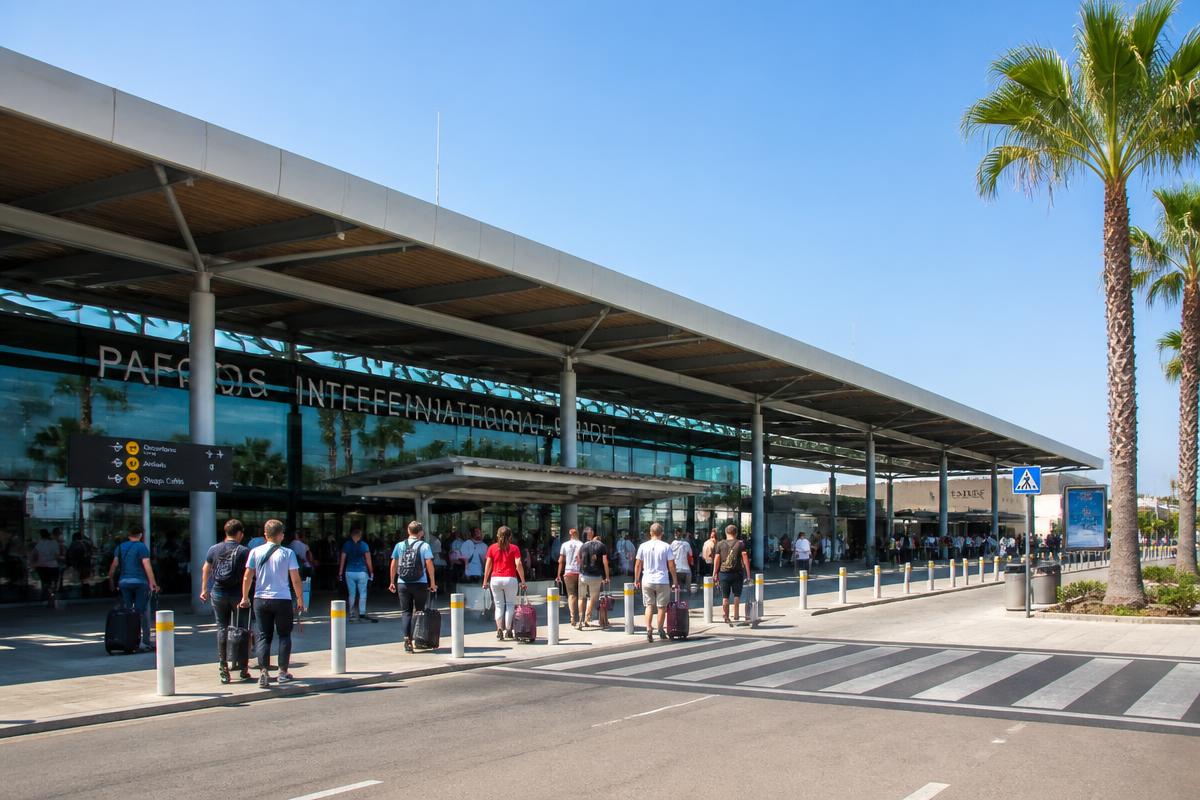 Paphos International Airport terminal exterior with arriving passengers
